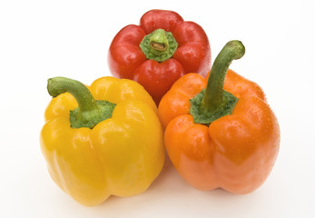 Red, orange, and yellow bell peppers on white background