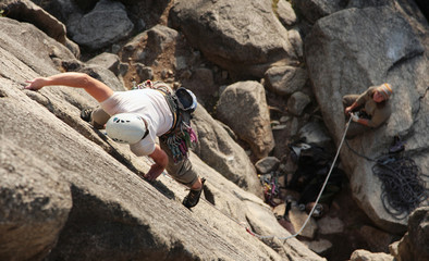 A female climber leads a popular route in Squamish, BC.
