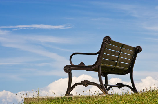 Wooden bench against a blue sky