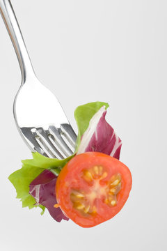 Fork with Fresh Salad isolated over white background