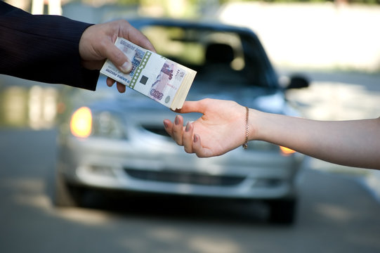 The buyer transfers money for the new car