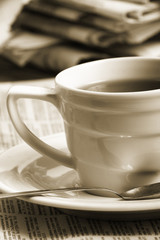 Cup  coffee on a morning paper business news