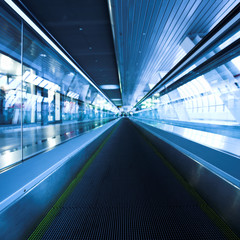 Blue moving escalator in the office hall perspective view