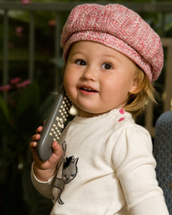 Adorable baby girl toddler in cute pink hat smiling