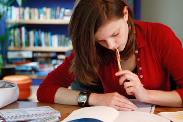 young female student doing her homework