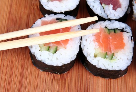sushi on bamboo with chopsticks