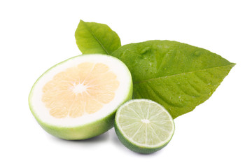 sweet grapefruit and green lemon with leaves isolated on white