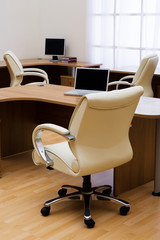 Beige leather armchairs at modern new office