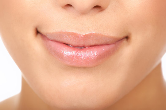 Beautiful young woman lips. Close up over  white background.