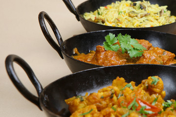 Lamb jalfrezi with vegetable curry and rice.