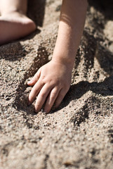 A four year old girl, playing outside.