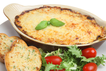 Individual lasagna with garlic bread and side salad