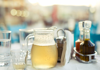 greek house wine in the carafe, shallow DOF