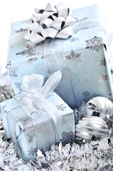 Wrapped gift boxes with silver Christmas ornaments