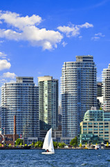 Sailboat sailing in Toronto harbour with scenic waterfront view © Elenathewise