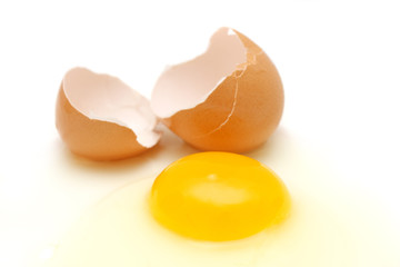Broken egg over white background.