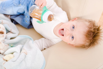 2 years old baby boy drinking from bottle