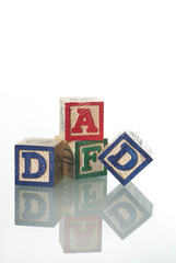 This is wood cubes piled up and three in the front say dad.