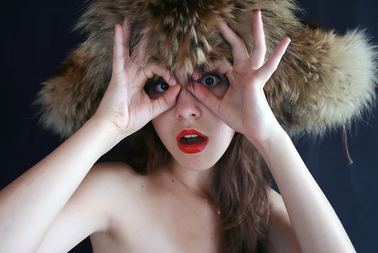 Portrait of the girl in a fur cap.