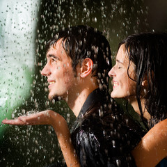 Young happy amorous couple hugging under a rain © vgstudio