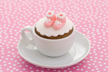 Christening cupcake with pink booties for a girl
