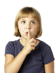Blonde 7 year-old girl with finger to lips
