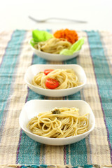 A row of  pasta olio in small square shaped bowls