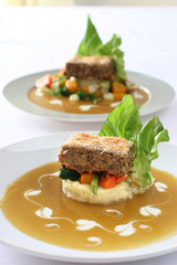 Gourmet meatloaf on a bed of vegetables