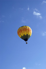 A single floating hot air balloon.