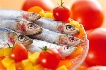 Group of sardines on different vegetables