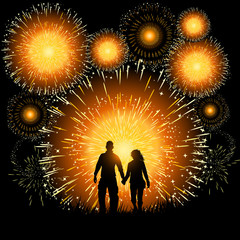 Fototapeta na wymiar A couple watch an amazing finale to a fireworks display.