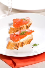 canape with smoked salmon, cream cheese spread and dill