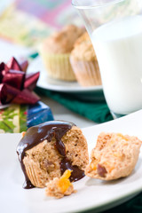 Whole grain muffins with chocolate sauce. Glass of milk