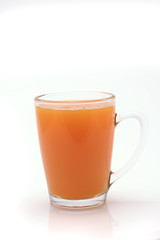 small transparent glass with orange juice