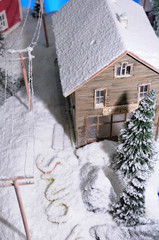 model of rural house covered by artificial snow