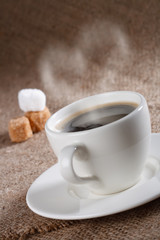 black coffee in white  cup with heart shape steam, shallow DOF