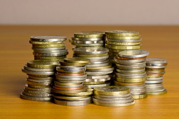 Stacks of coins placed on top of a table.