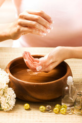 Beautiful fingers with French manicure and white flowers