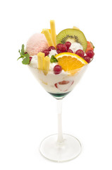 Fresh juicy fruit cocktail with whipped cream and syrup