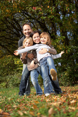 Fototapeta premium happy family of four enjoying their day off in nature
