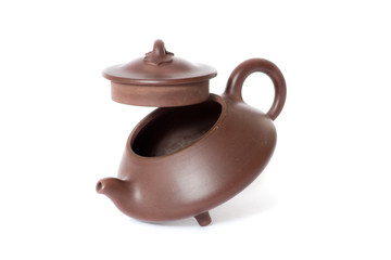 Brown ceramic chinese teapot. White background