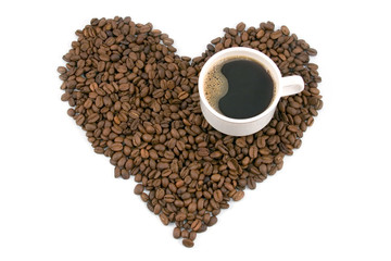 coffee cup with heart shaped coffee beans in the background..