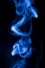 Blue smoke on black background