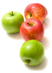 Red and green apples covered by water drops on the white