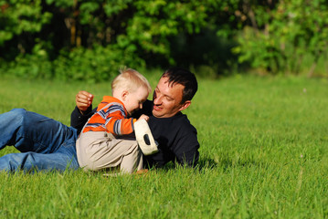 Fototapeta premium Happy father and the son on the nature in the summer