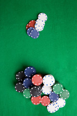 A large stack of poker chips on a green felt