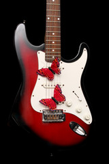 electric guitar with fake red butterflies