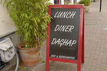 Chalkboard sign with today's lunch and diner written on it