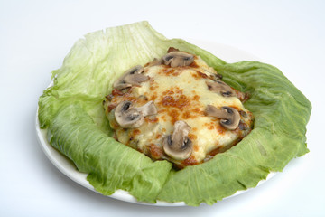 Meat baked with cheese and mushrooms.