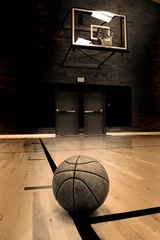 Foto op Canvas Basketball on court with hoop in the background © Lane Erickson